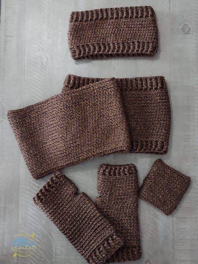 crochet elkhorn ear warmer in brown yarn, 2 crochet elkhorn neck warmers in brown yarn, crochet elkhorn fingerless gloves in brown yarn, crochet elkhorn cup sleeve in brown yarn.